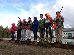 Young hunters in a row with guns