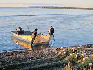 Kotzebue fishermen with net and boat on the beach