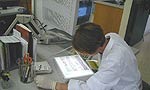 A lab worker scoring gels