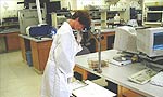 A lab worker photographs gels