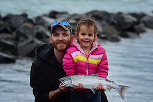 A girl, her dad, and a fish