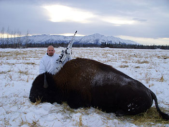 Successful bison hunter with harvested bison