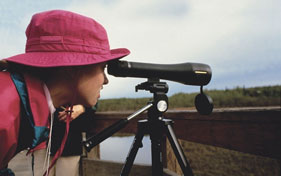 Woman looking through telescope