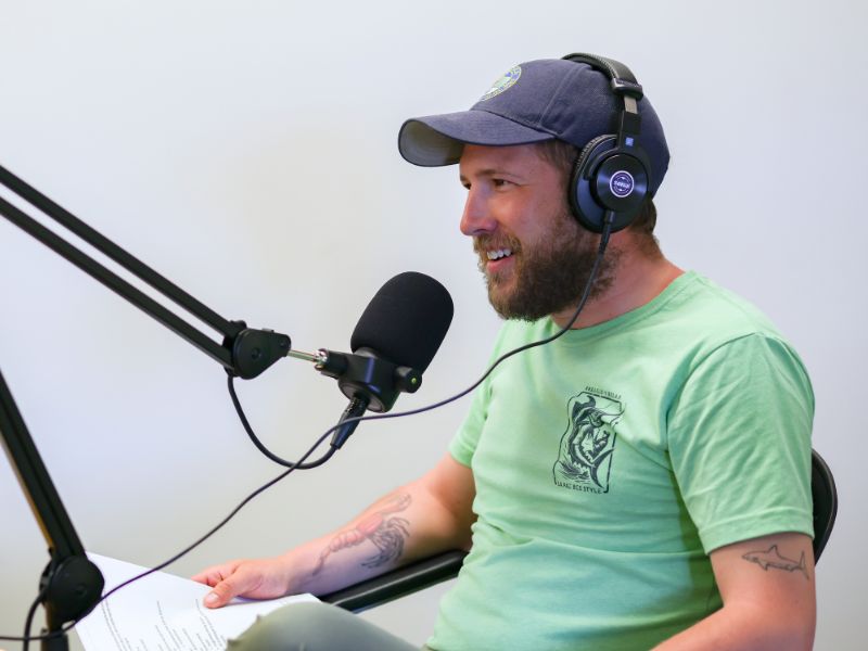 Donald speaking into a microphone with headphones on