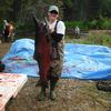 College Intern, Jenna Fortier, uses both hands to hold up an impressive Chinook salmon during the Deception Creek eggtake.