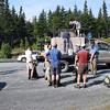 Fish and Game employees and volunteers wait in anticipation for their empty backpacks to be loaded with rainbow trout fingerling. The group splits up to hike fish into several small lakes in the Kenai without motorized access.