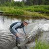 Fish Culturist I, Megan McClaren, stocks Chinook smolt into Deception Creek.