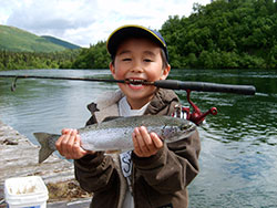 Boy holding fish he caught