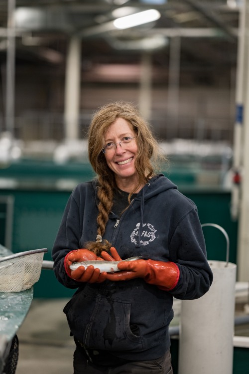 Staff handing a rainbow trout