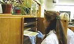 A lab worker removes stained gel from incubator