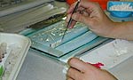 A lab worker loads the gel with samples