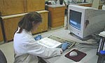 A lab worker scoring gels