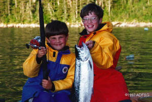 Two kids with fishing pole and catch