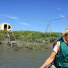 The only way to reach the sonar site is by boat. At the sonar site, sonar transducers submerged in the river detect fish and a WeatherPort tent houses electronics and computers to receive and store sonar data.