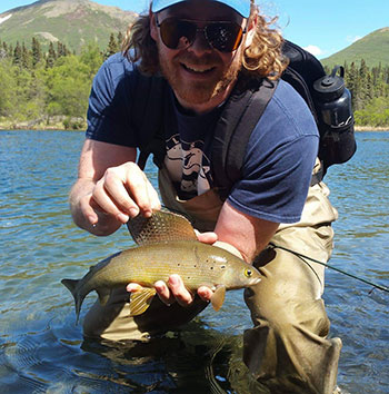 Man with Arctic grayling