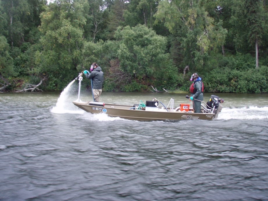 ADF&G biologists apply the fish piscicide rotenone to Stormy Lake during the lakeâ€™s treatment in fall 2012