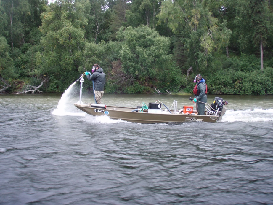 ADF&G biologists apply the fish piscicide rotenone to Stormy Lake during the lake’s treatment in fall 2012