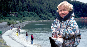 Boy with fish on beach
