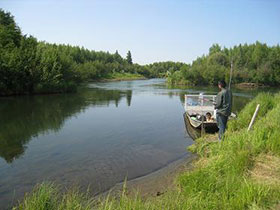 Rod and reel fishing location on a Kuskokwim tributary accessible by boat.