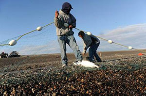 Fishermen with net on a beach